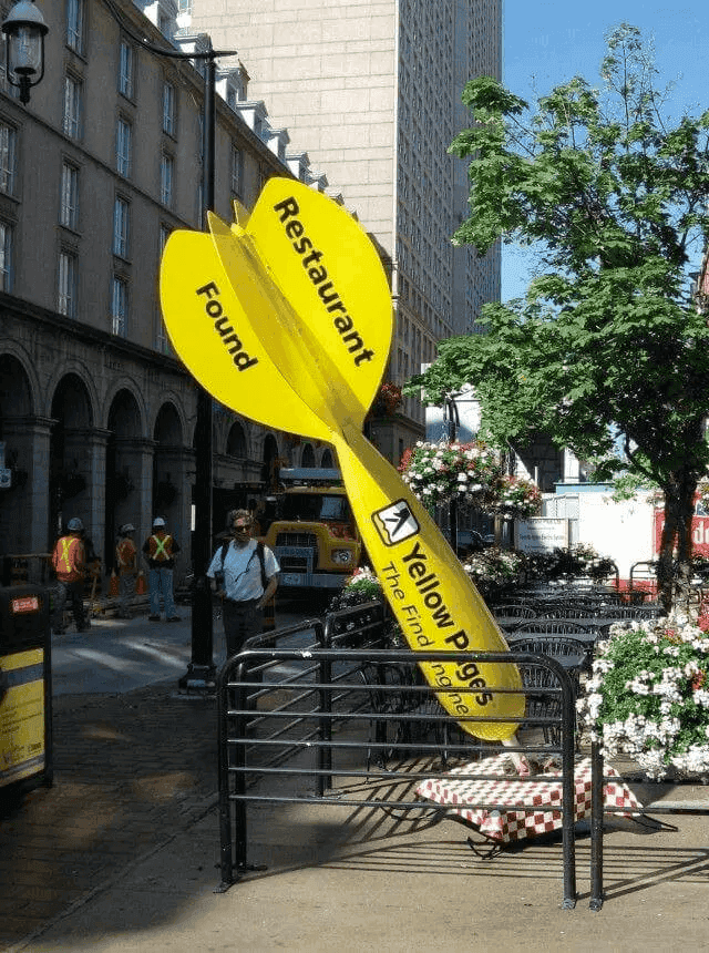 Yellow Pages guerrilla tactic, giant dart touching base at a restaurant