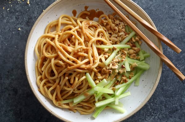 Asian cuisine with sliced cucumber and wooden chopsticks