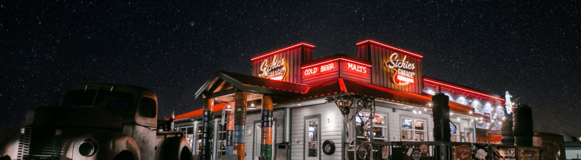Sickies Garage restaurant lit up at night