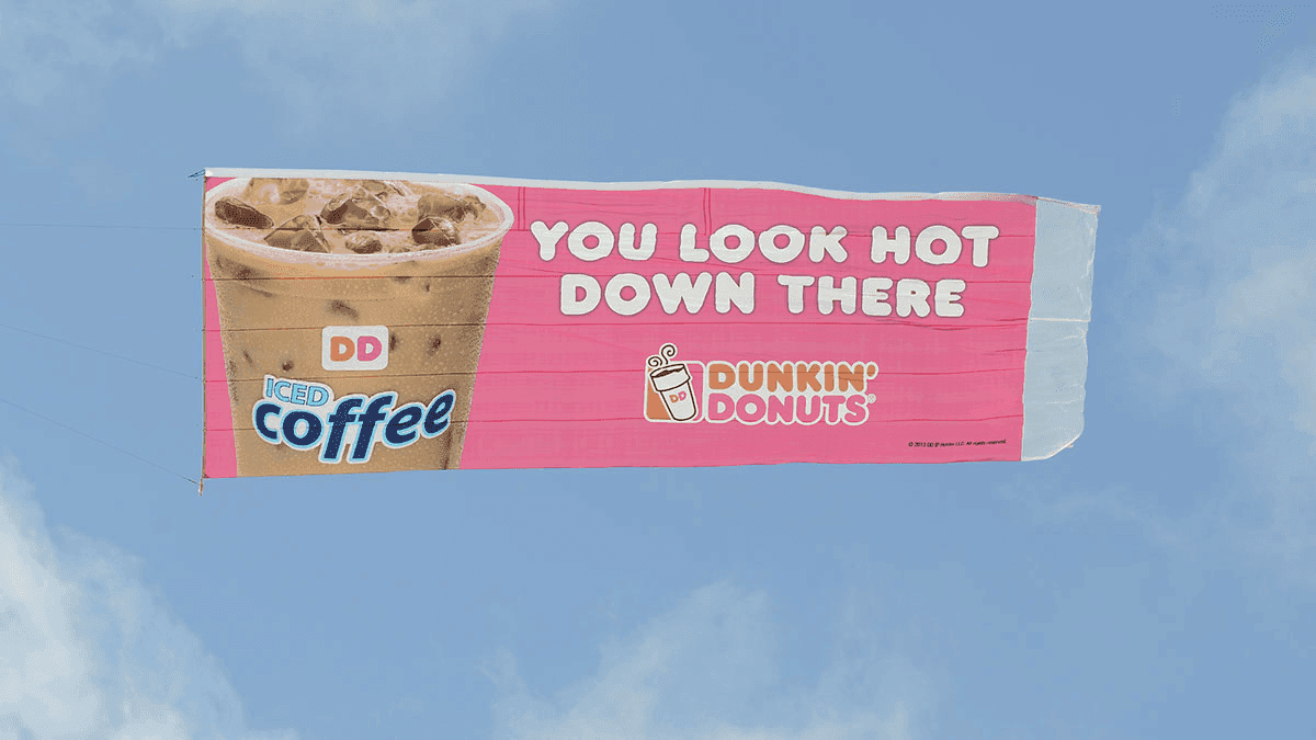 Dunkin Donuts iced coffee banner behind an airplane