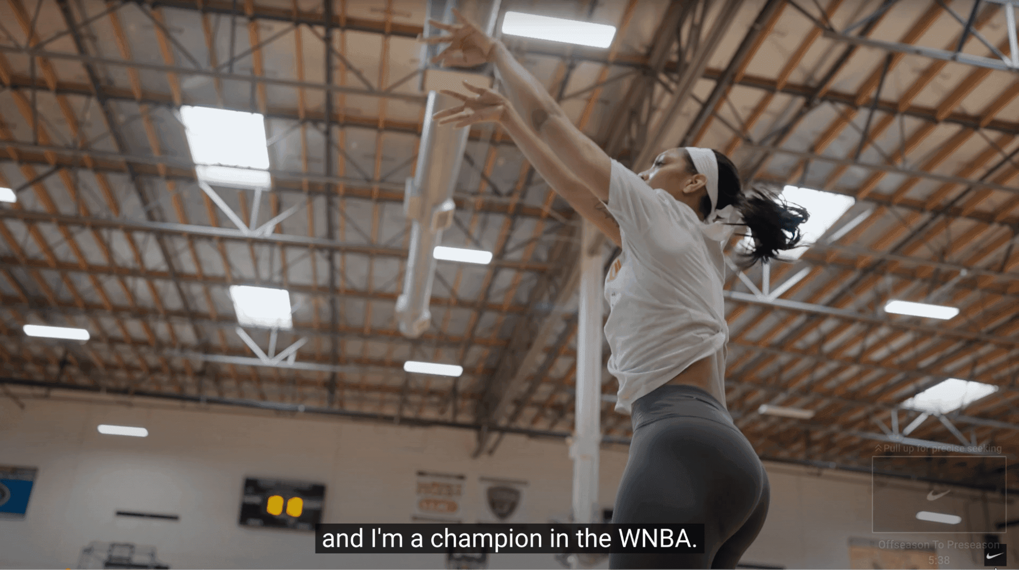 WNBA player A'ja Wilson shooting a basketball in Nike ad