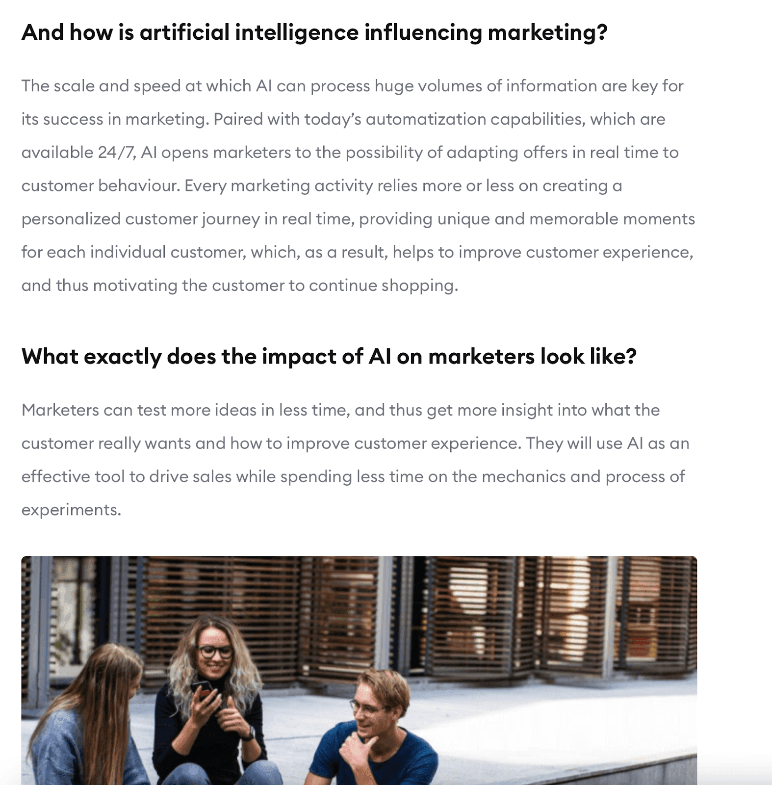 The impact of AI in marketing article with picture of three people sitting while talking