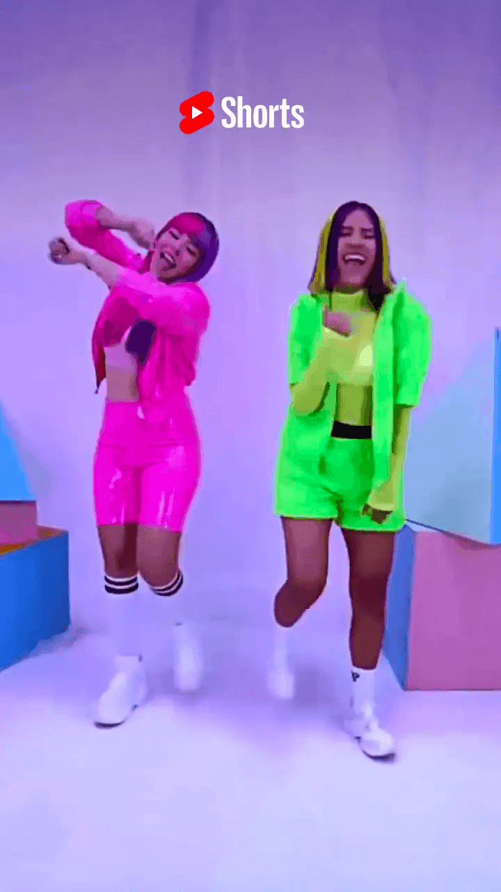 Two women dancing in neon colored clothing