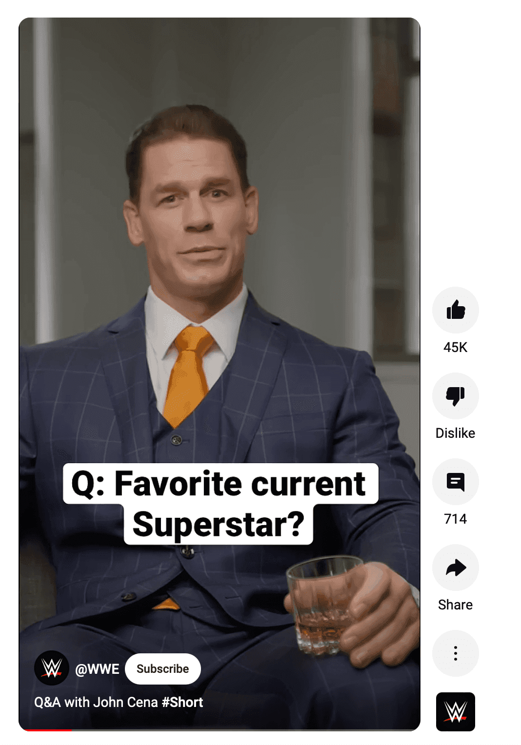 John Cena sitting in a suit